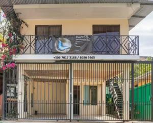 a building with a balcony with a sign on it at Apartamentos Morpho CR 2 in Quepos