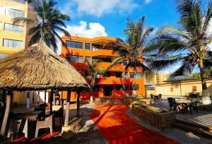 a resort with palm trees and a building at Tucacas, Sotavento in Boca de Aroa