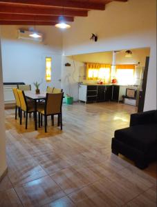 a living room with a table and chairs and a kitchen at ALQUILER X DIA Merlina in Catriel