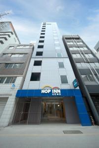 a large building with a hop inn sign on it at Hop Inn Tokyo Ueno in Tokyo