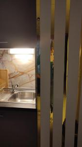 a kitchen with a sink and a counter at ESCAL'HOME , appart design au pied de l'aéroport,parkings in Blagnac