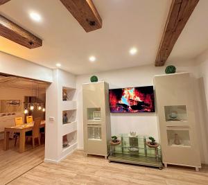 a living room with a table and a tv on a wall at Ferienwohnung Missa in Bayreuth +4 photos