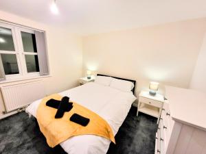 a bedroom with a bed with a cross on it at Stay Sleep Rest - Heeley in Heeley