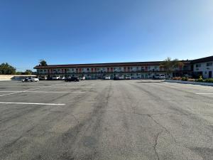 an empty parking lot in front of a building at The Dixie Orange County in Stanton