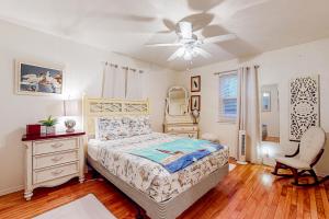 a bedroom with a bed and a ceiling fan at Monte Ne Getaway in Rogers