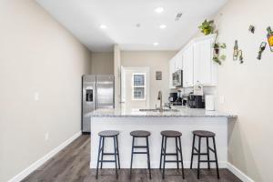 a kitchen with a counter and three bar stools at Vineyards Escape 3 in Branson