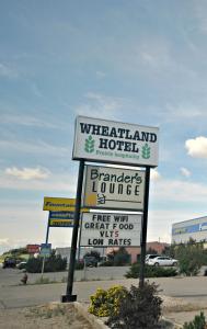 a sign for a hotel in a parking lot at Wheatland Hotel in Strathmore