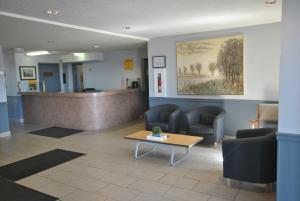 a waiting room with chairs and a reception desk at Wheatland Hotel in Strathmore