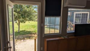 an open door to a porch with a view of a yard at Quiet Condo close to Laguna Madre -B in Corpus Christi