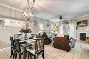 a dining room and living room with a table and chairs at Luxury Condo, Sleeps 6, 3.2 Miles to Dollywood in Pigeon Forge
