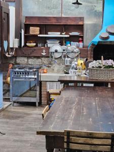 a kitchen with a stove and a table in it at VILLA VILLACOLLE in Procchio