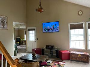 a living room with a flat screen tv on the wall at Happy Place in Conley