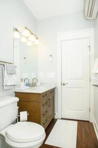a white bathroom with a toilet and a sink at BayRidge house by Quiet Waters, Thomas Point Parks in Annapolis +17 photos