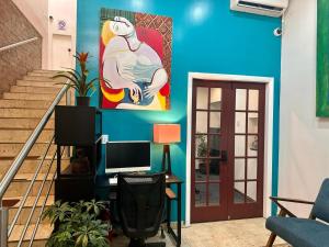 a living room with a blue wall and stairs at INTJ Hotel in Tijuana