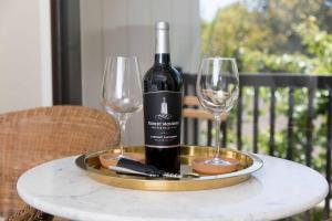 a bottle of wine on a tray with two wine glasses at Couple's Retreat in Napa Valley Near Wineries in Napa