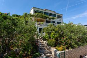 a house with a garden in front of it at Apartments by the sea Cove Gornja Krusica, Solta - 20021 in Stomorska