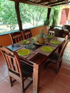 a wooden table with green plates on it on a patio at Casa Amapola in La Cruz