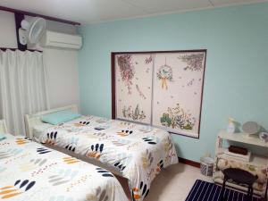 Ένα ή περισσότερα κρεβάτια σε δωμάτιο στο Mike's B&B Tokoname