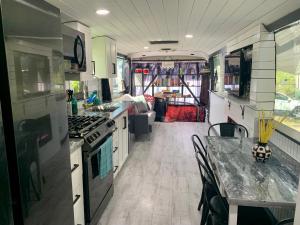 a kitchen and dining area of an rv at Pet friendly tiny home, No extra fees! The Jitney in Clermont