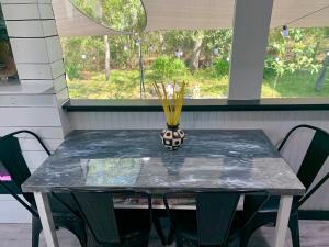 a table with a vase on top of it at Pet friendly tiny home, No extra fees! The Jitney in Clermont