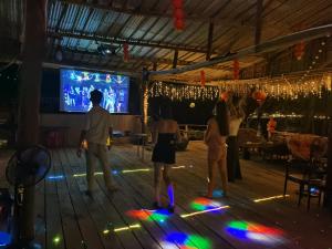 a group of people playing a video game on a dance floor at Dreamer of the sea in Koh Rong Sanloem