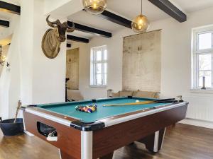 a room with a pool table and a skull on the wall at 20 person holiday home in Svendborg in Svendborg