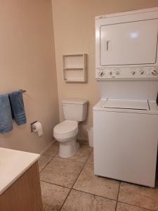a small bathroom with a toilet and a sink at 1st Floor Condo in the Desert w/ Pool, Spa & BBQ in Lake Havasu City
