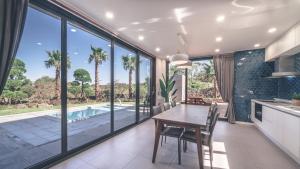 a kitchen and dining room with a table and a pool at Jeju Private unit for family or group in Jeju