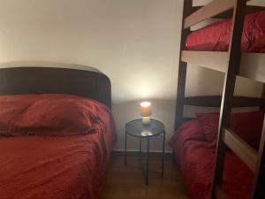 a bedroom with a bed and a table with a candle at Hostal EntreOrientes in Viña del Mar