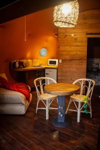a kitchen with a table and chairs in a room at Willkay Glamping Raco Tucumán in Tafí Viejo