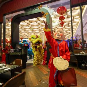 a group of people dressed in costumes in a restaurant at Fili Hotel at Nustar Cebu in Cebu City