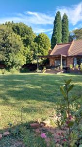 a large yard with a house in the background at Wapadrand Guest Suite in Pretoria
