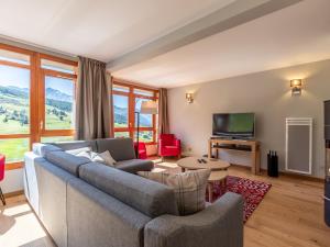 a living room with a couch and a television at Appartement Les Arcs 1800, 4 pièces, 6 personnes - FR-1-352-57 in Arc 1800