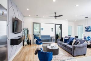 a living room with a couch and a table at Stylish 3 Story Townhouse near East Downtown in Houston