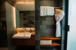 a bathroom with a sink and a mirror at Grün Canggu Garden in Canggu