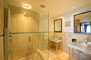 een badkamer met een glazen douche en een wastafel bij Coral Beach Club Condo Dawn Beach condo in Upper Princeʼs Quarter