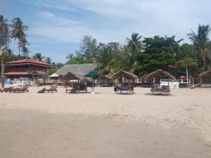 a beach with chairs and umbrellas on the sand at Udayam guest in Trincomalee