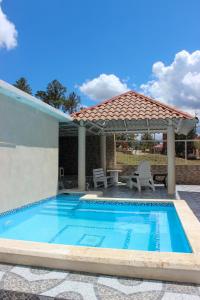 a swimming pool with a gazebo at Villa Raynell in Constanza