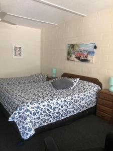 a bedroom with a bed and a picture on the wall at Motel Bream in Mallacoota