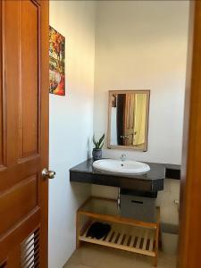 a bathroom with a sink and a mirror at D32 Homestay near airport Behind Brown coffee airport in Phnom Penh