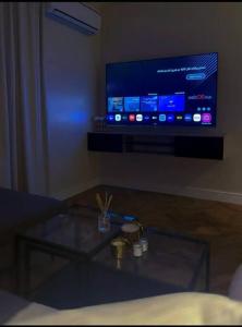 ein Wohnzimmer mit einem Tisch und einem Flachbild-TV in der Unterkunft شقة فاخرة بدخول ذاتي in Riad