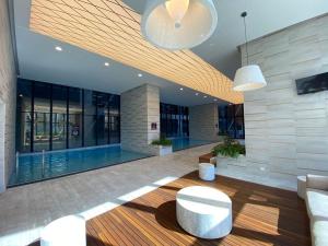 a lobby with a swimming pool in a building at Melbourne Cbd 2br Apt With Pool Gym in Melbourne