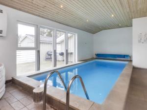 a large indoor swimming pool with a large window at Holiday home Rødby LVI in Rødby