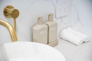 two bottles ofodorizers sitting on a counter in a bathroom at Elegance and Style in Wagga Wagga