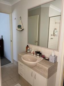a bathroom with a sink and a large mirror at Ascot on Swan Bed & Breakfast in Perth +11 photos