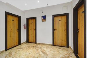 ハイデラバードにあるTownhouse Hitec City Near Image Hospitalの壁に3つの扉がある部屋