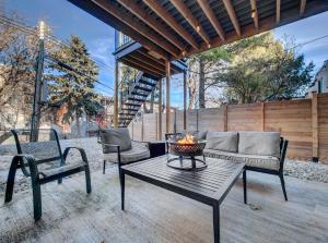 a patio with a couch and a table and chairs at Cozy & Luxurious 3-BR condo (4min to metro) in Montreal