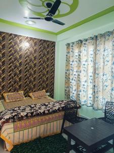 a bedroom with a bed and a ceiling fan at Siya home stay in Faizābād