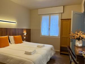 a bedroom with a bed and a table and a window at Cà di Buole 8B in Mestre