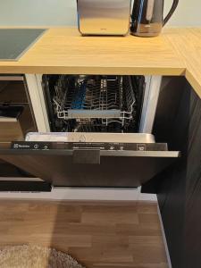 an open dishwasher in a desk with a drawer at Upea yksiö ydinkeskustasta. in Lappeenranta